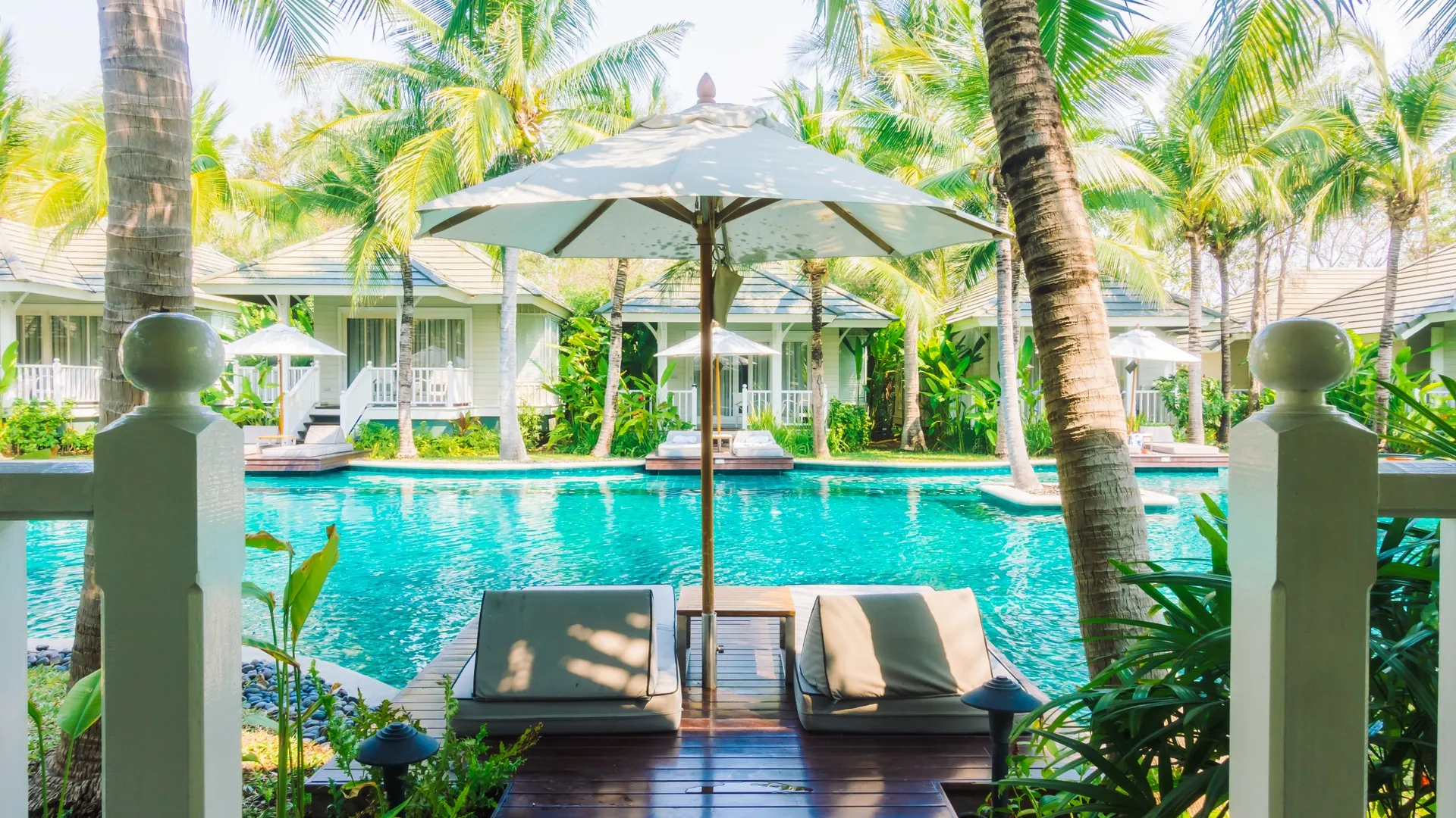 Luxury resort pool with tropical villas