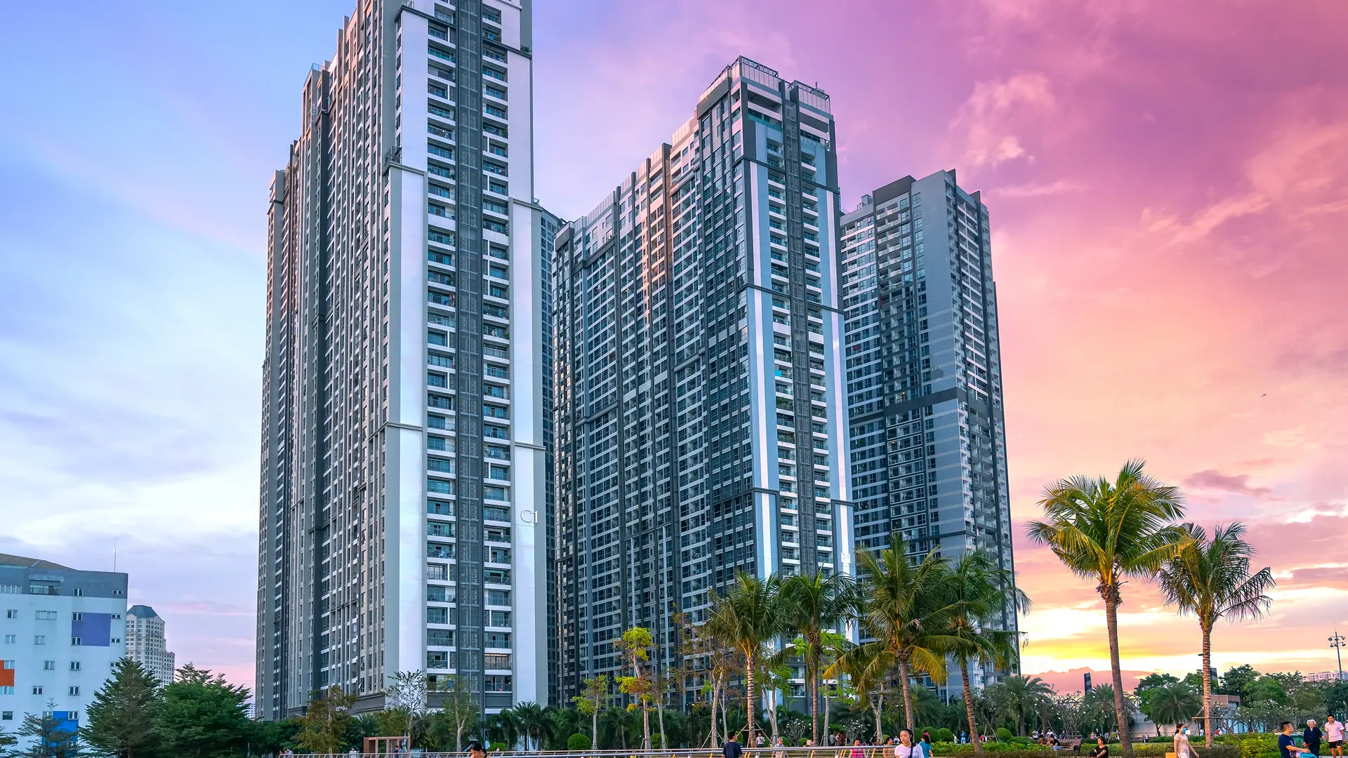 People enjoying an outdoor courtyard event at a modern residential complex